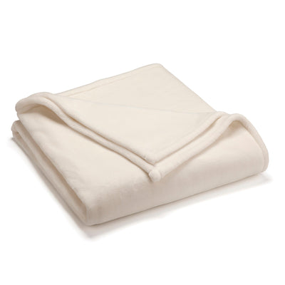 Cream-colored sheared faux mink blanket folded neatly.