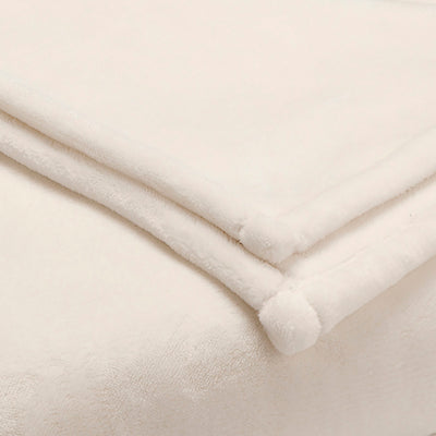 Soft, sheared faux mink blanket in a light cream color, folded with rounded corners.